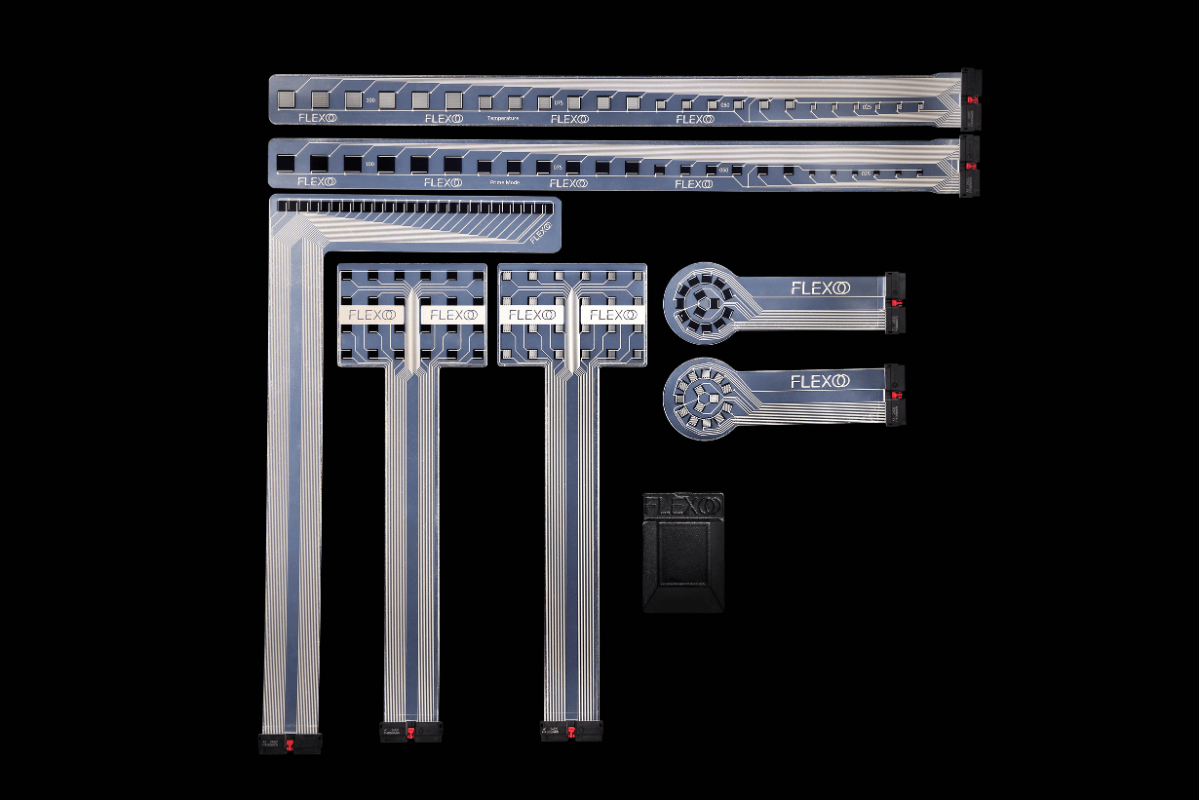 All items of the FLEXOO MultiMoS set arranged as a group of sensor foils in different shapes plus read-out electronics