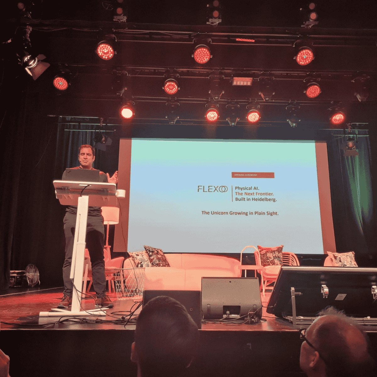 Sieer Angar from FLEXOO standing on stage at the AI Conference 2026 in Heidelberg